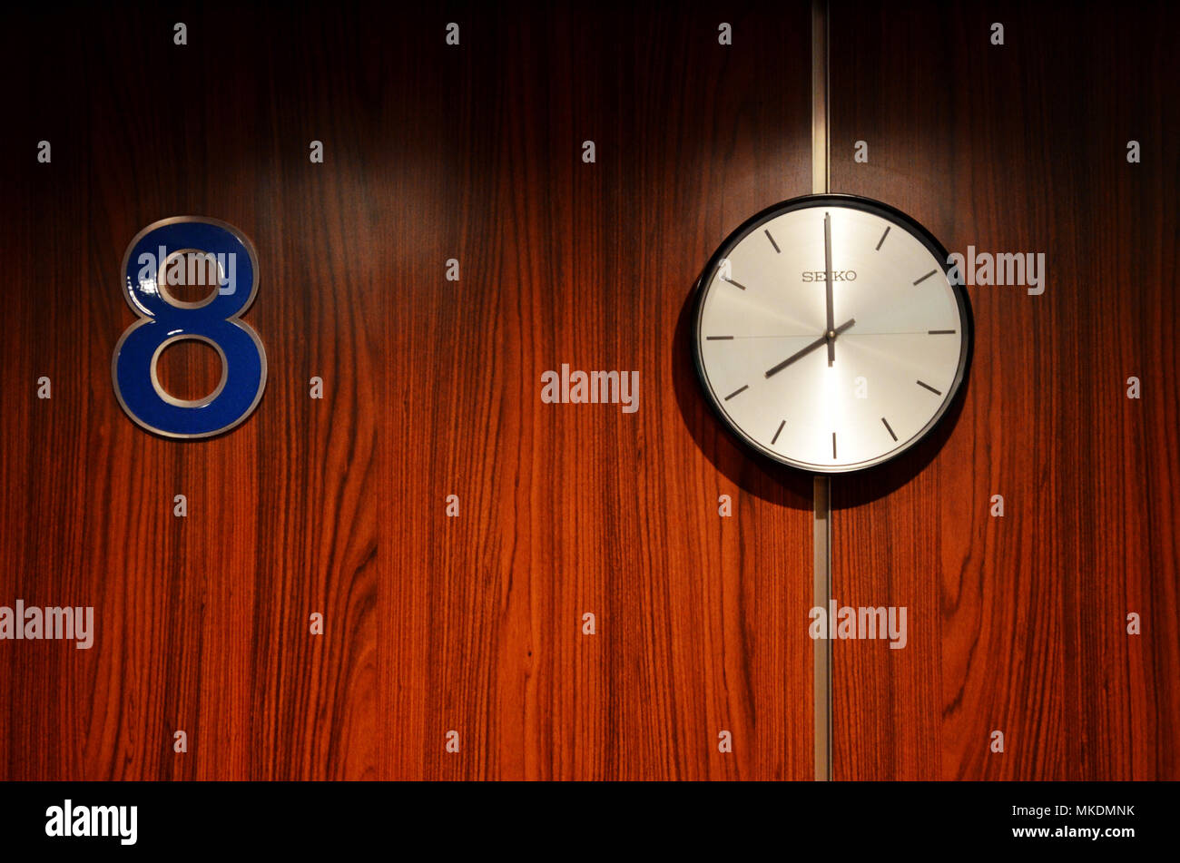 Number 88. Clock on wall showing eight o'clock next to number eight ...