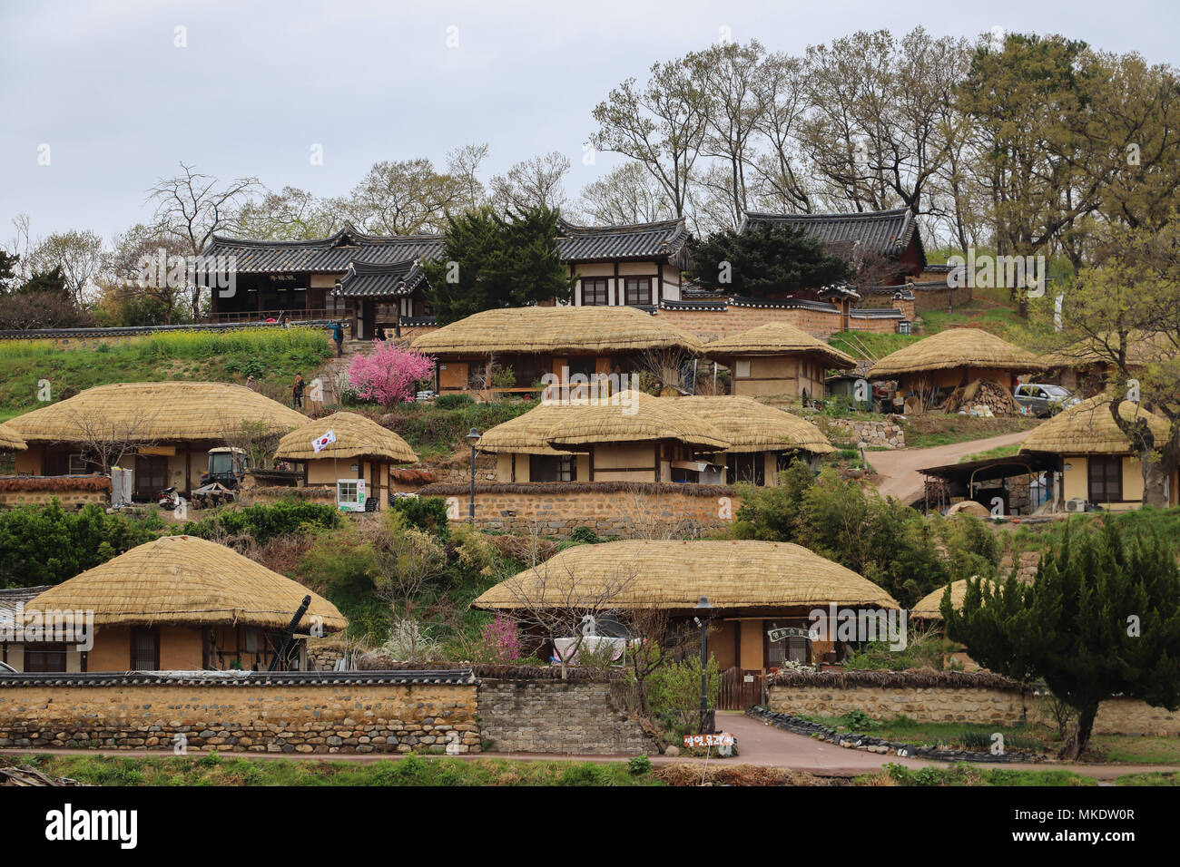 Tiled roof houses of head clans on top of hill, thatched roof houses lower down in Yangdong Village, near Gyeongju, South Korea, a UNESCO site. Stock Photo