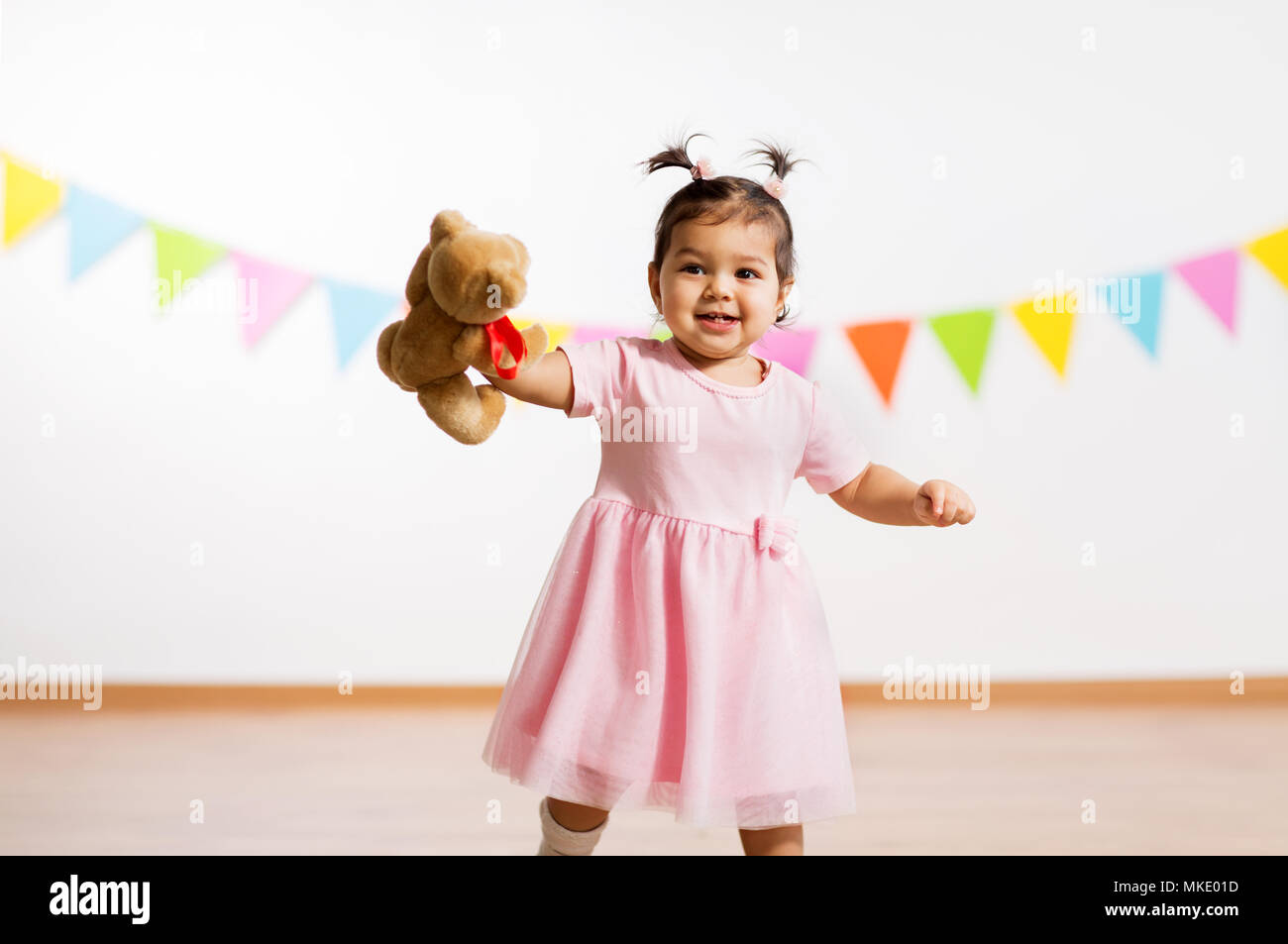 happy baby girl with teddy bear on birthday party Stock Photo - Alamy