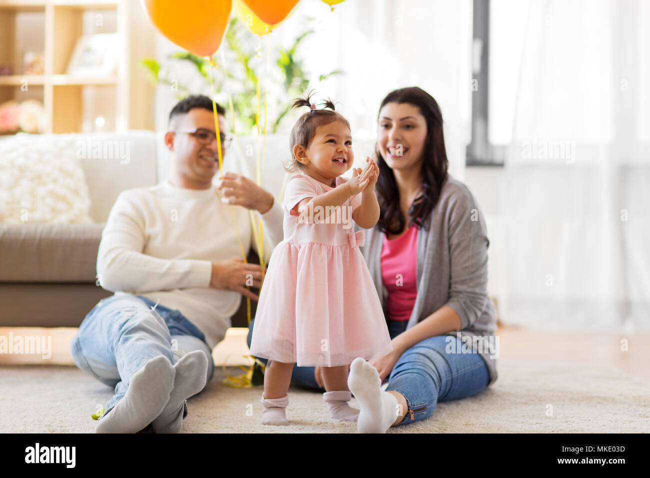 happy baby girl and parents at home birthday party Stock Photo - Alamy