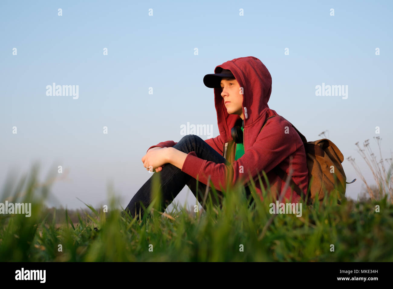 Teenager on green lawn Stock Photo