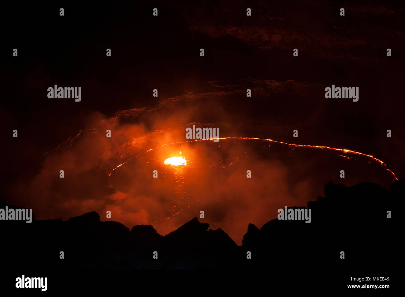 The lava lake of the Ert-Ale volcano, the fiery lava creates a bright red contour in the night darkness, Northern Ethiopia. Stock Photo