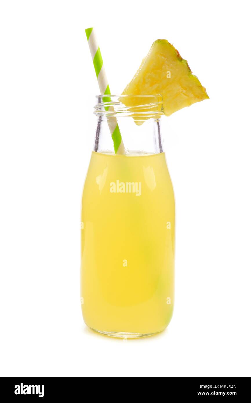 Pineapple juice in a milk bottle style glass with straw isolated on a white background Stock Photo