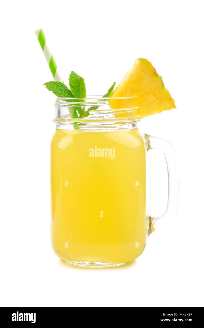 Pineapple juice in a mason jar glass with mint and straw isolated on a white background Stock Photo