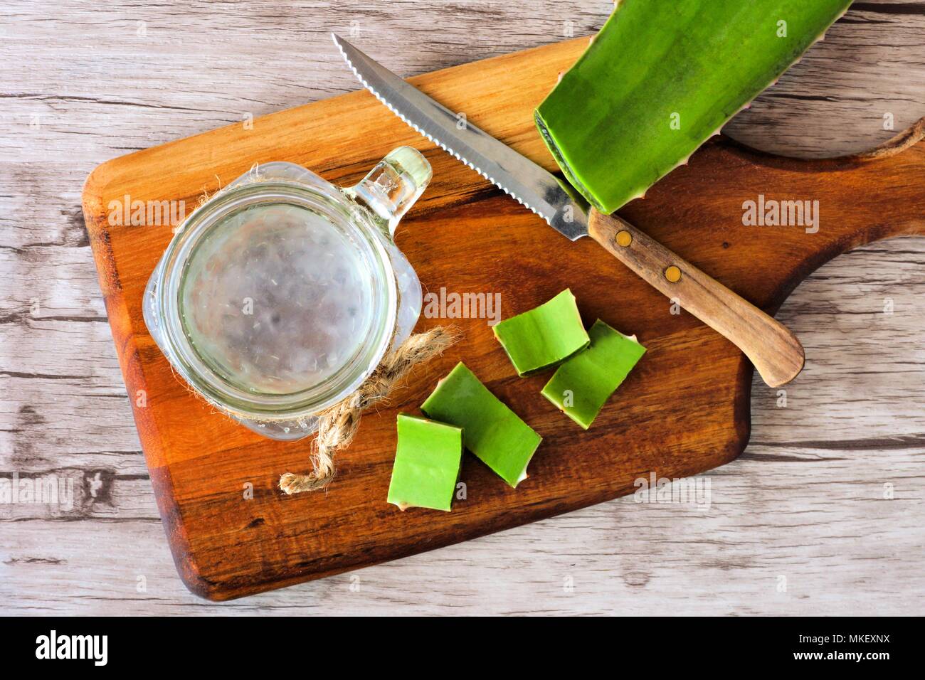 Healthy Aloe vera juice in a mason jar glass. Top view scene on a wooden paddle board. Stock Photo