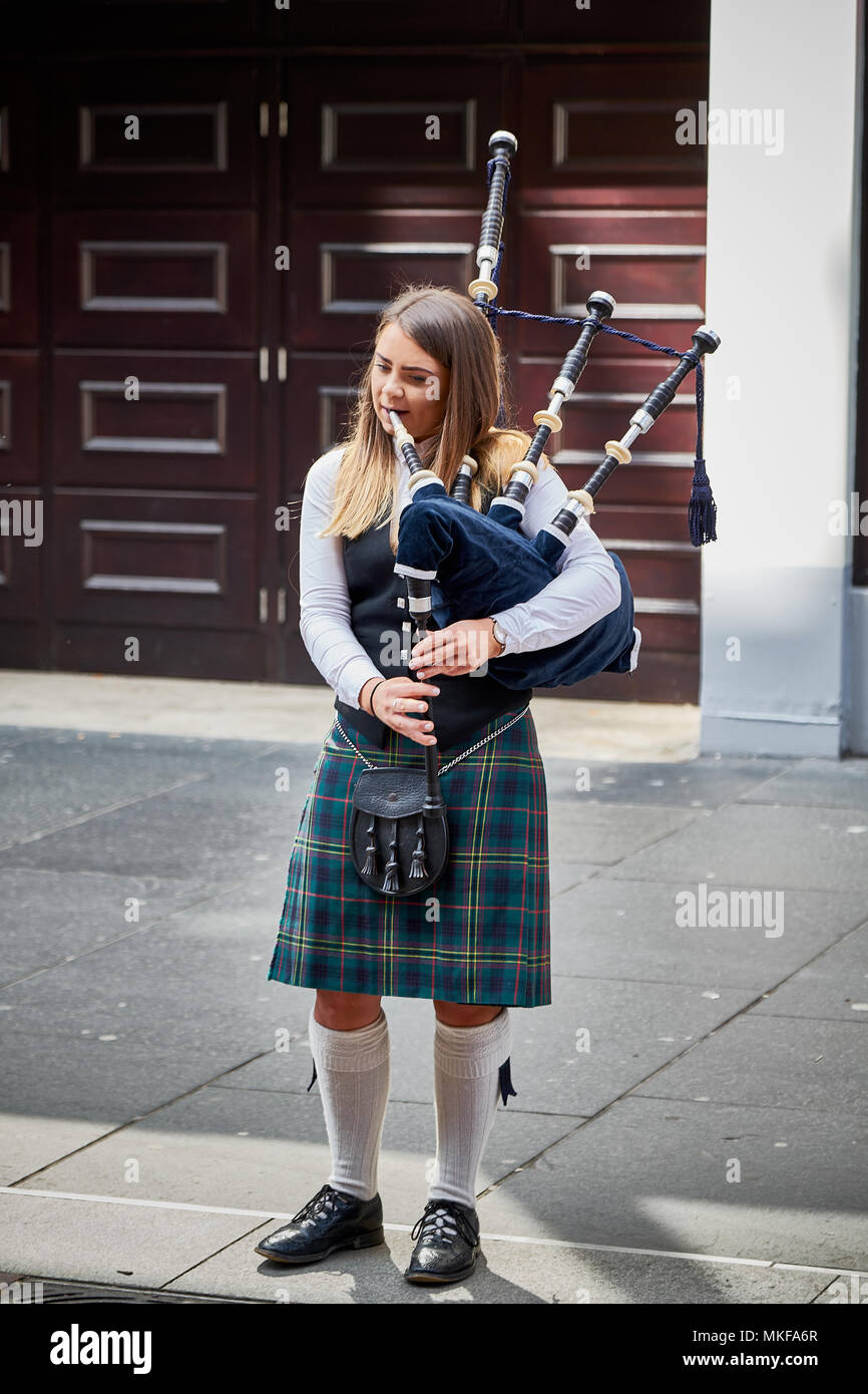 Young Girl Bagpiper Playing Bagpipes On Street Outside In City Glasgow 