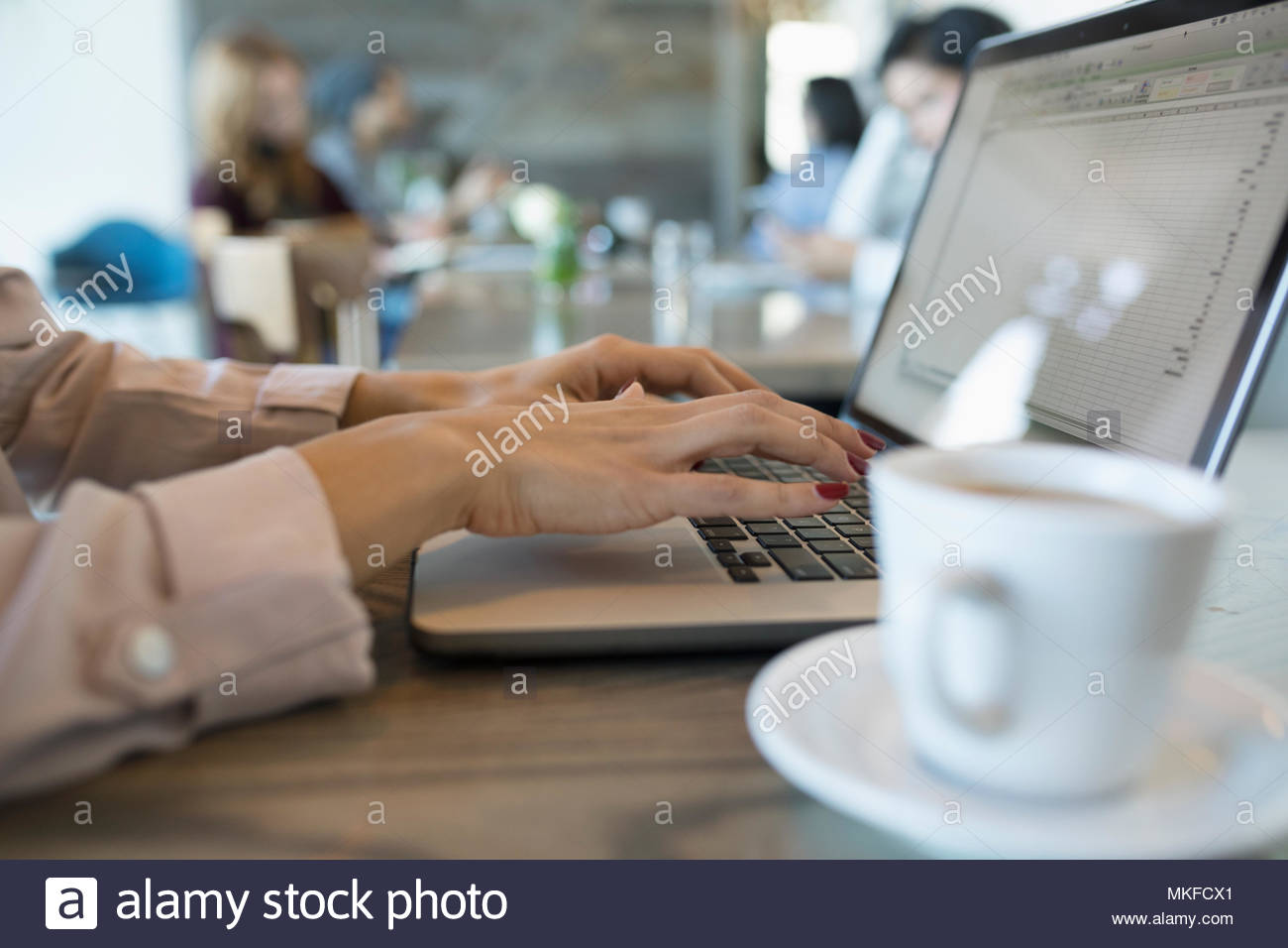 Close up businesswoman typing, working at laptop in cafe Stock Photo