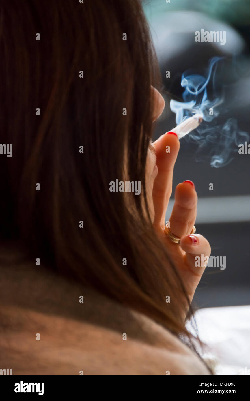 Woman smoking cigarette Stock Photo - Alamy