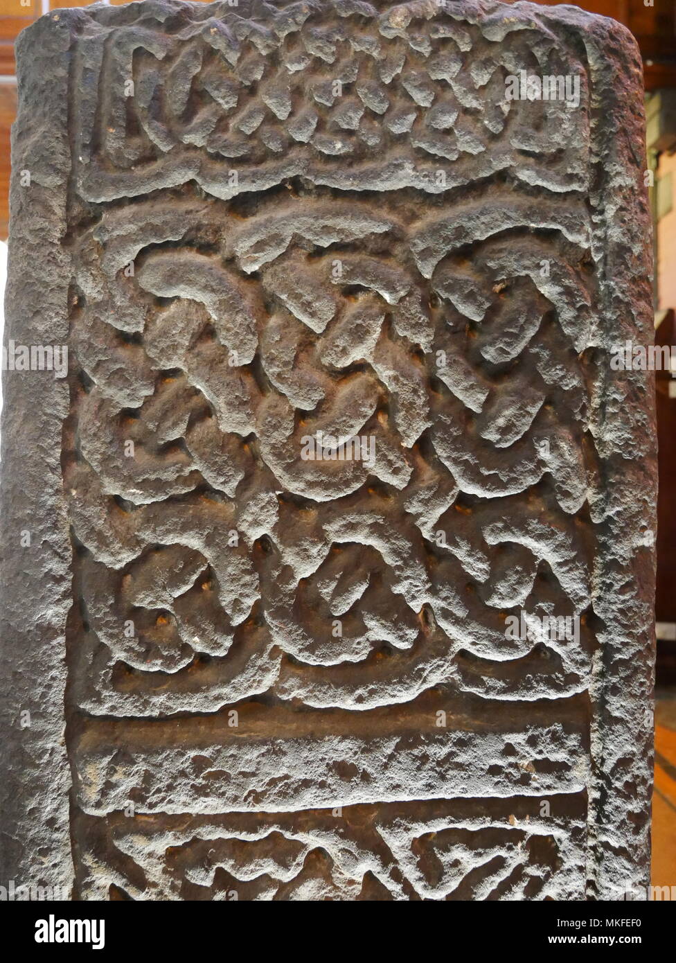 Close up of Celtic style carvings on back of Jordanhill Cross Stone in Govan Old Church, Glasgow. Stock Photo