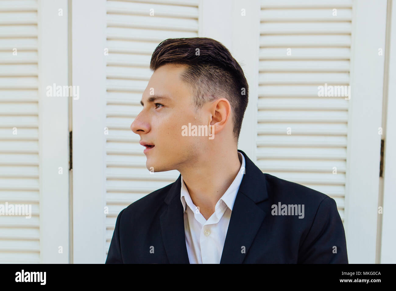 Portrait of handsome man in black suit Stock Photo - Alamy