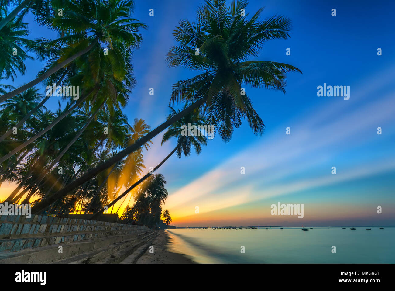 Sun Rays Tropical Sunrise on the tropical beach with sun rays piercing through the ...