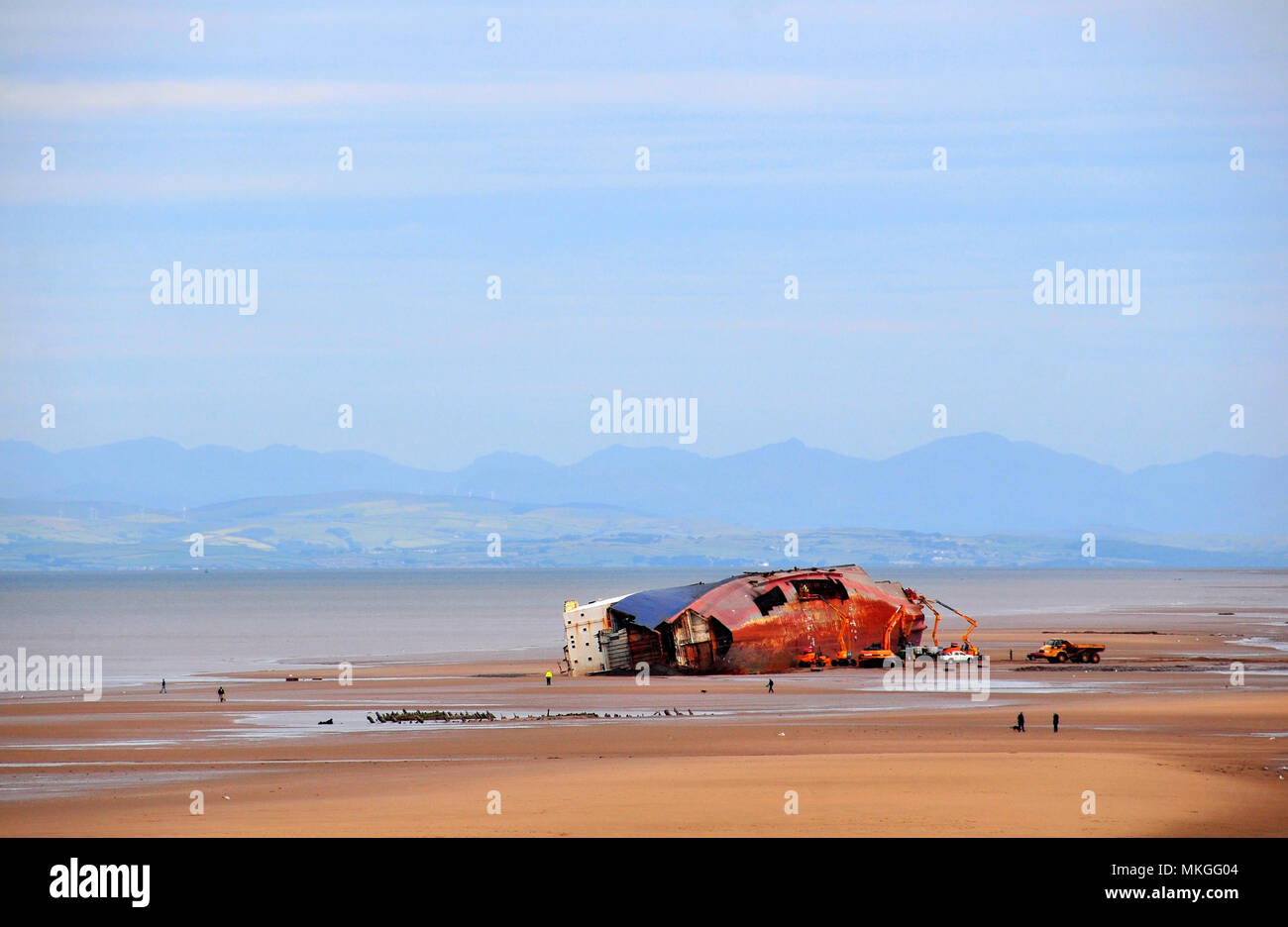 View from promenade, to Lake District Fells, of Abana and Riverdance Ferry Wrecks on low tide sand beach, Anchorsholme, Cleveleys, Lancashire, UK Stock Photo