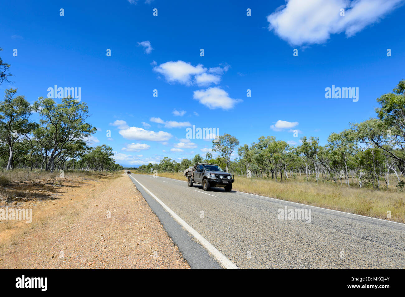 Cars motoring along the emote Mulligan Highway between Mt Molloy and