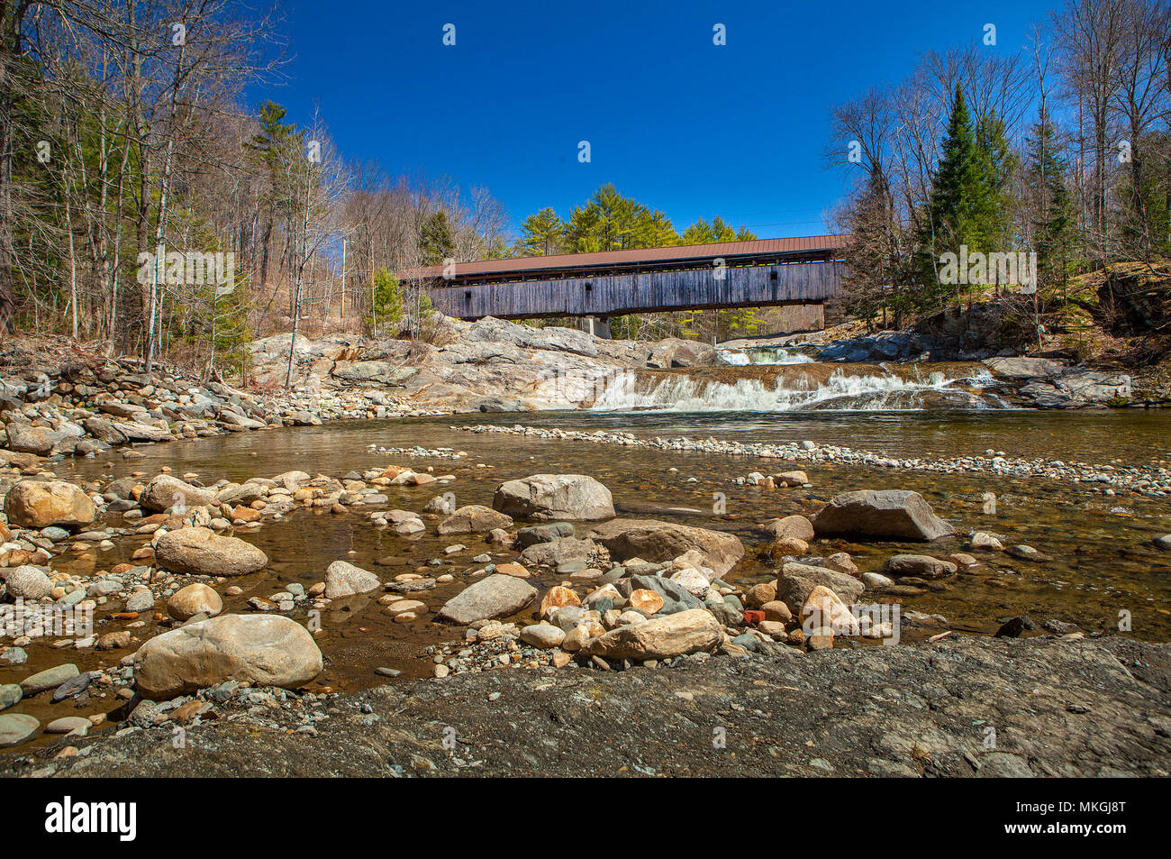 The Swiftwater at Bath, NH covered bridge spans the Wild Ammonoosuc River,  a favorite summer swimming hole and gold prospecting site. Stock Photo
