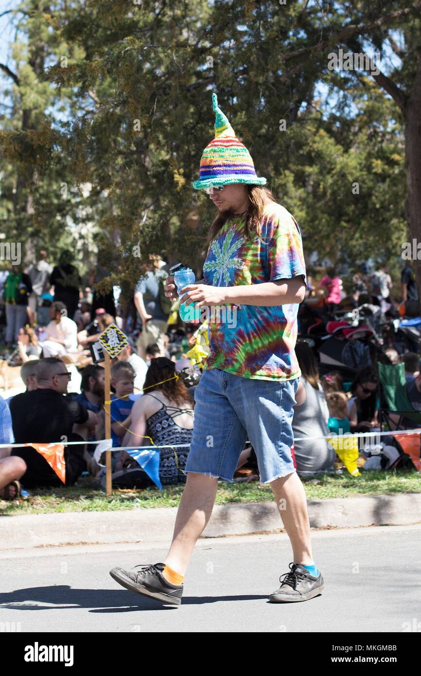 A hippie wearing tie dye and a pointed hat at the May Day festival