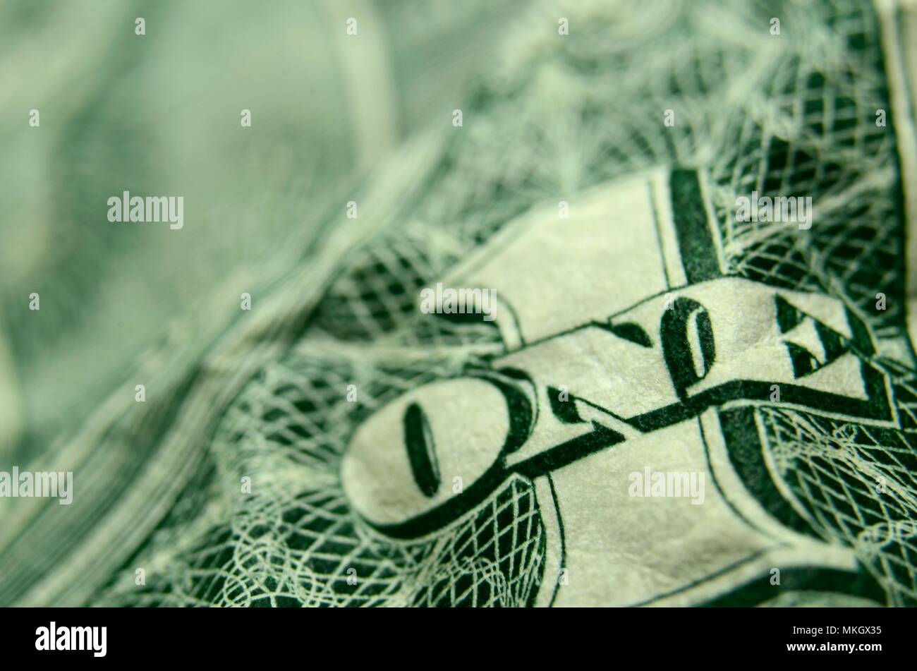 Shallow depth of field close up of the ONE on a wrinkled American dollar bill. Stock Photo
