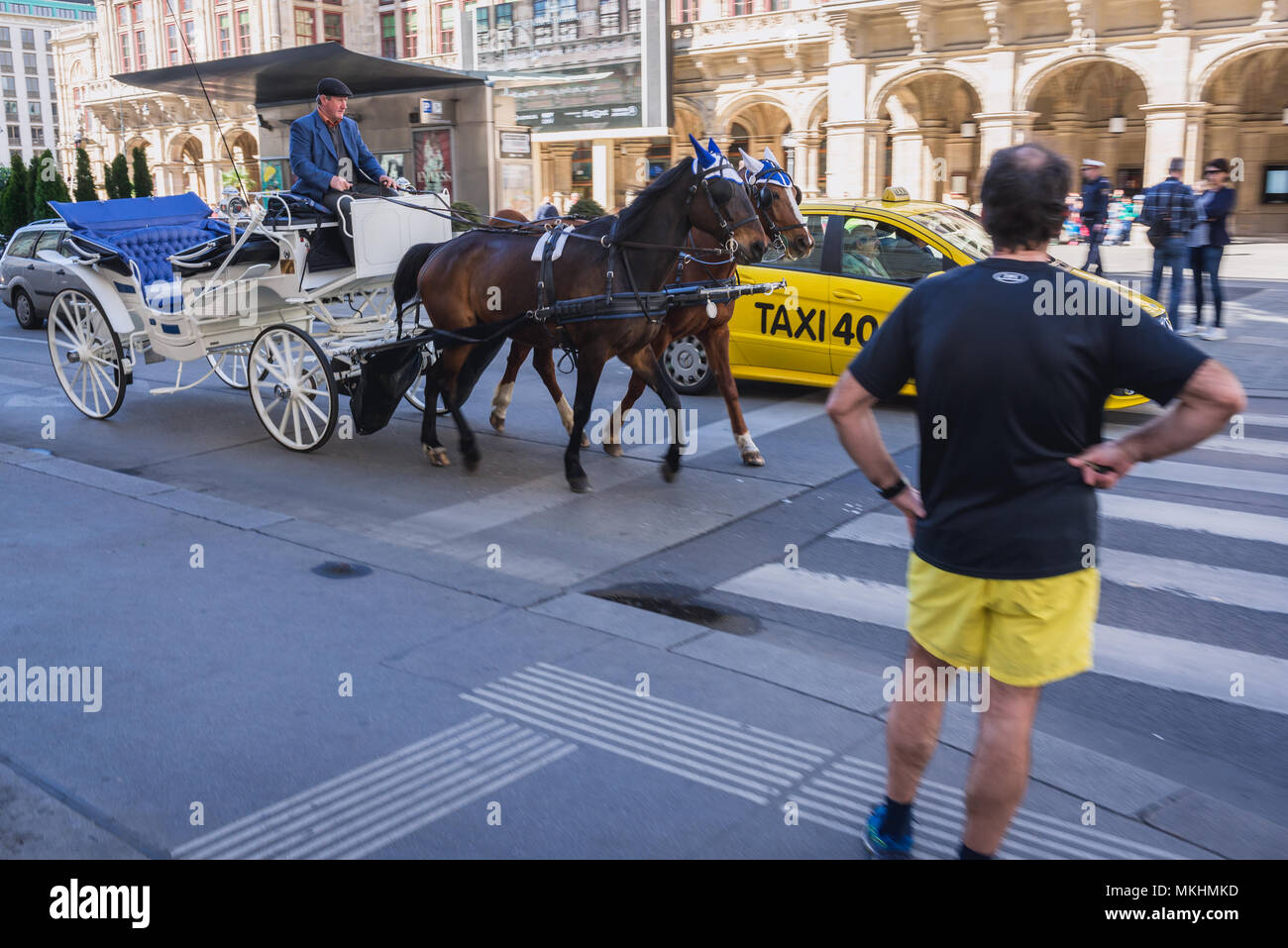 Horse-drawn carriage called Fiaker in front of Vienna State Opera in Vienna, Austria Stock Photo