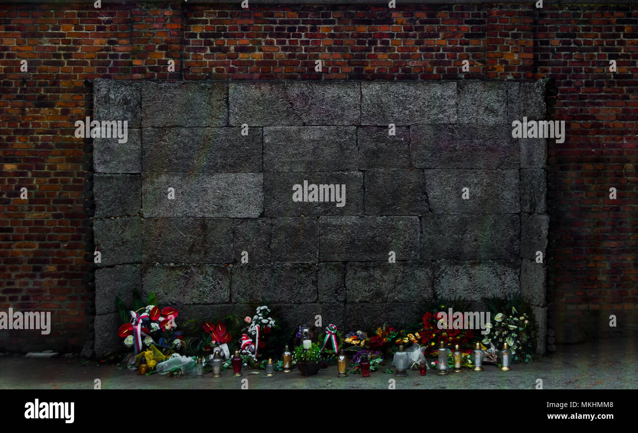 Wall of the executions at the Auschwitz Nazi concentration camp, Poland. Place decorated with flowers dedicated to the victims. Stock Photo