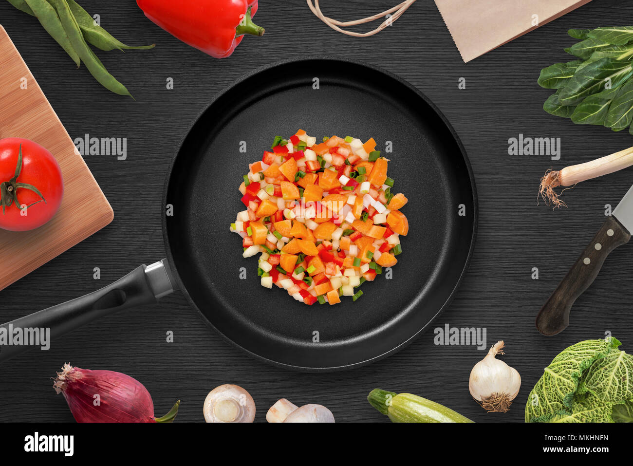 Frying pieces of vegetables in a pan. Preparing ingredients for head dish. Vegetarian cuisine. Top view. Stock Photo