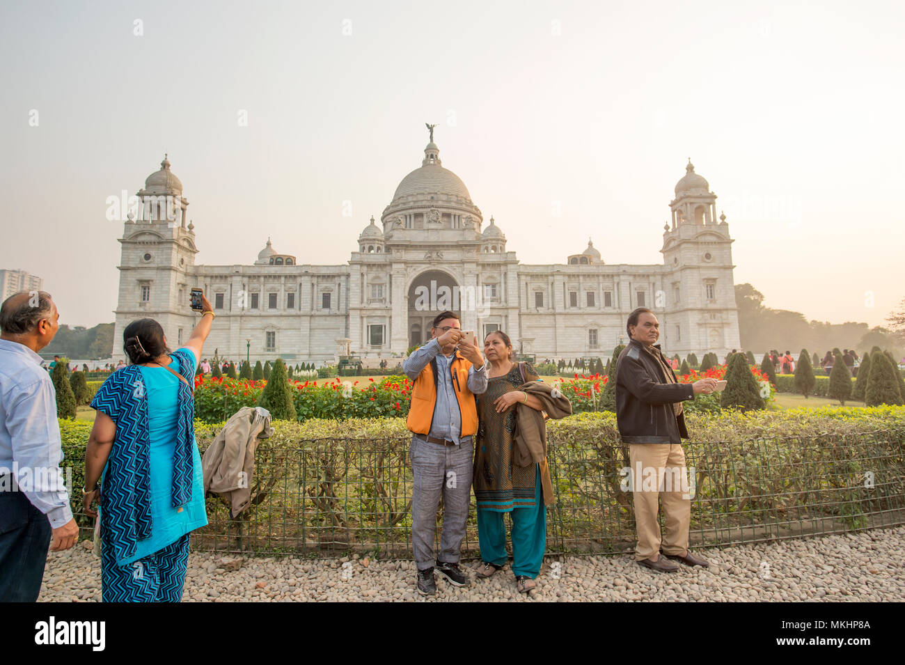 KOLKATA - INDIA - 20 JAN 2018. Some tourists in a traditional Indian dress are taking pictures in front of the Victoria Memorial Hall in Kolkata. Stock Photo