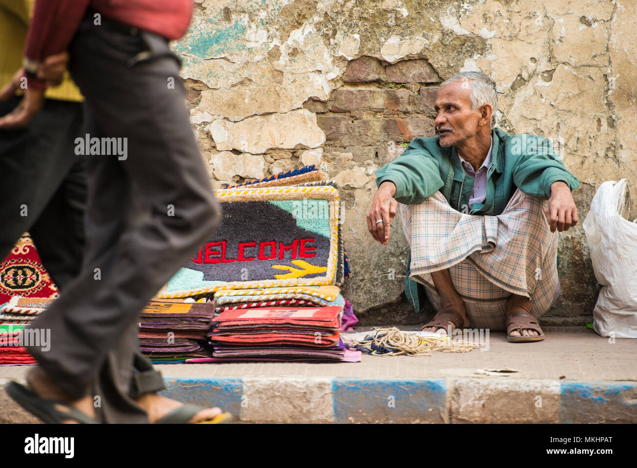 Poor street vendor selling carpet hires stock photography and images