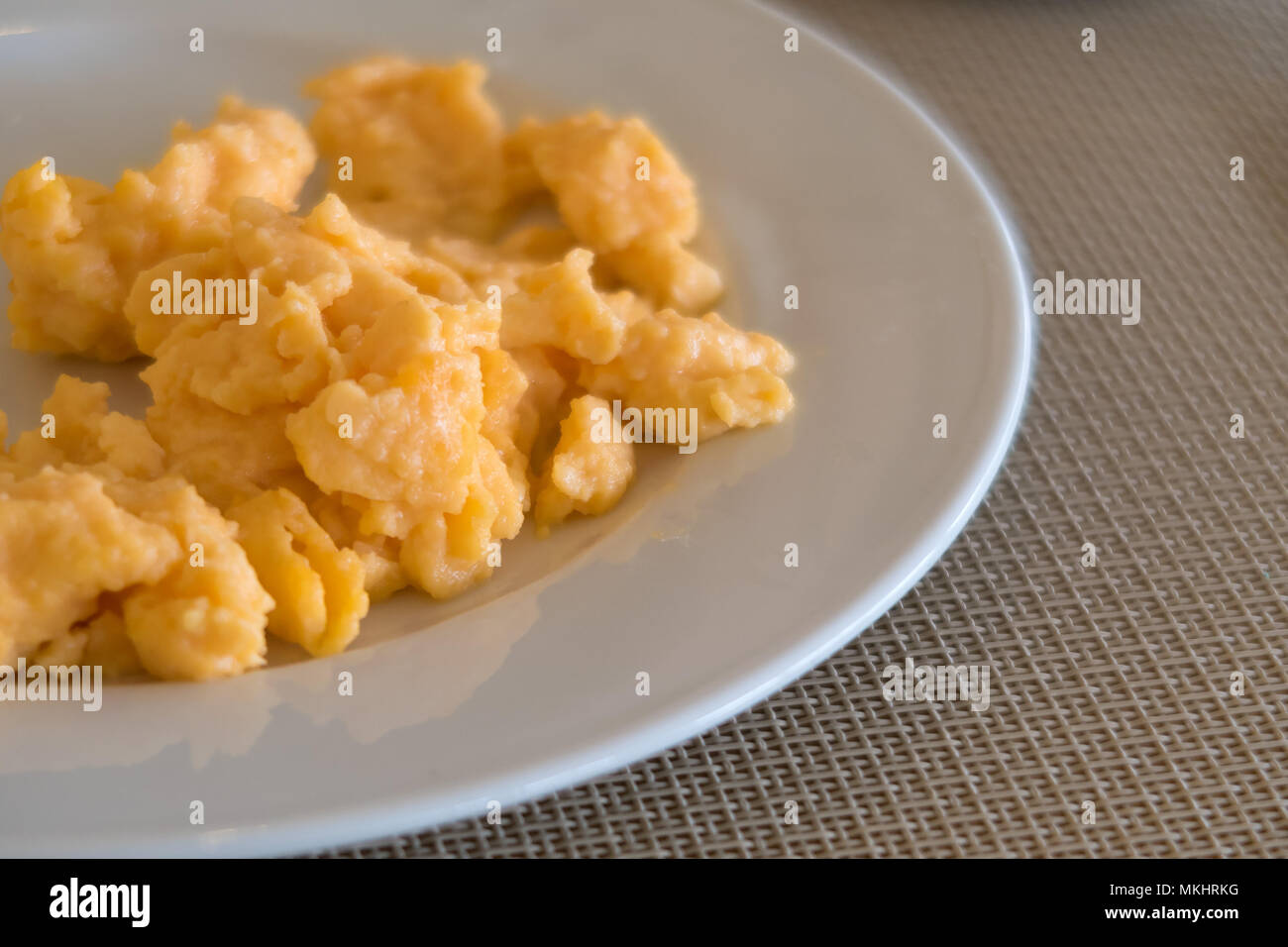 Scrambled eggs on a white plate Stock Photo