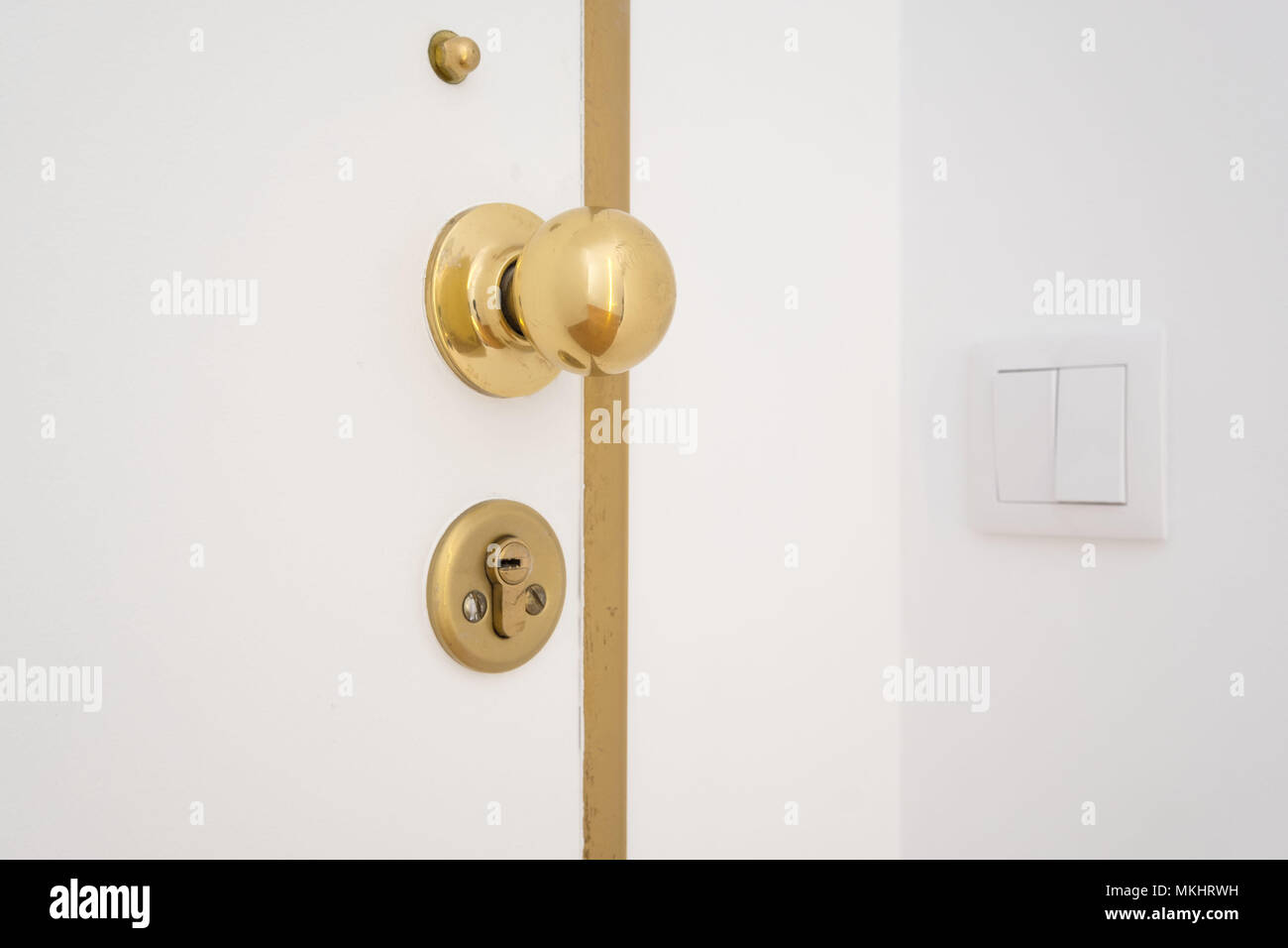 Golden door knob and keyhole Stock Photo