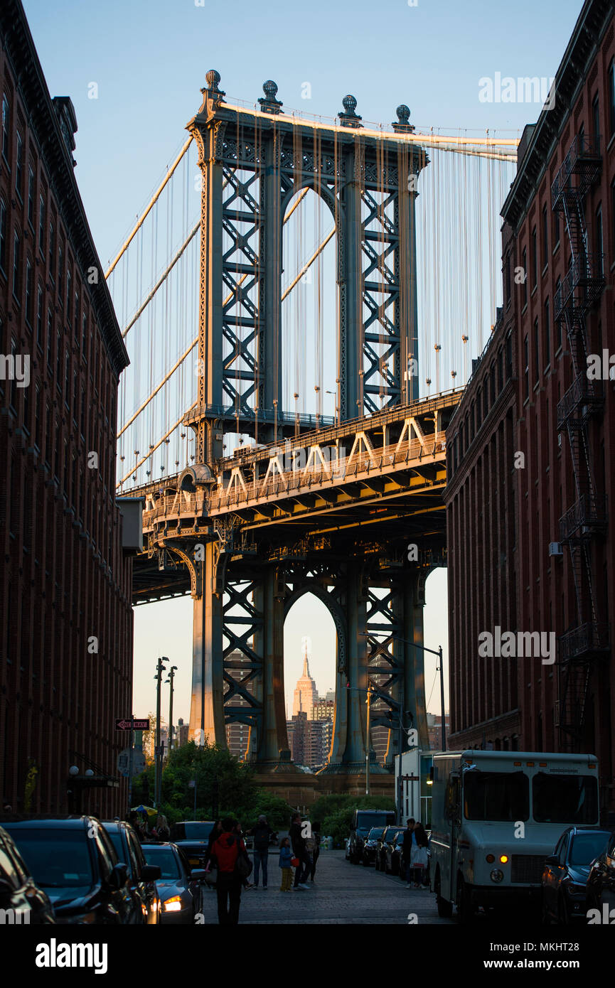 Brooklyn bridge seen from a narrow alley enclosed by two brick ...