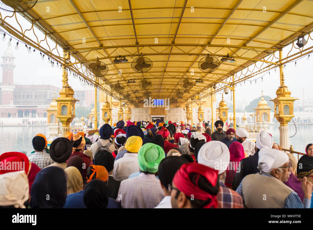 AMRITSAR, INDIA - NOVEMBER 13, 2017: Tourists and pilgrims waiting in line at the entrance The Harmandir Sahib (Golden Temple) Stock Photo