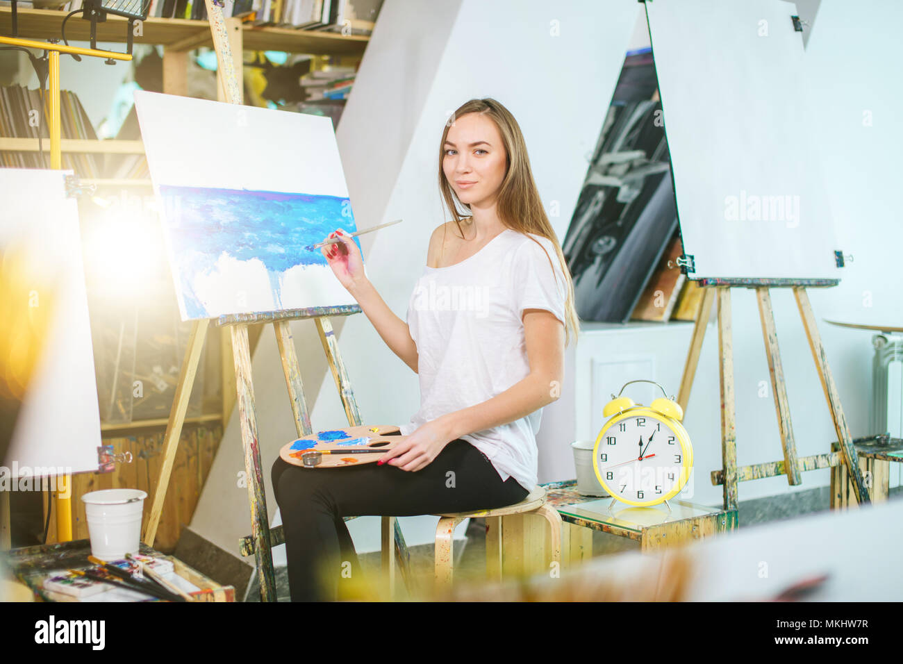 Female student painter taking drawing lesson and looking at camera in ...
