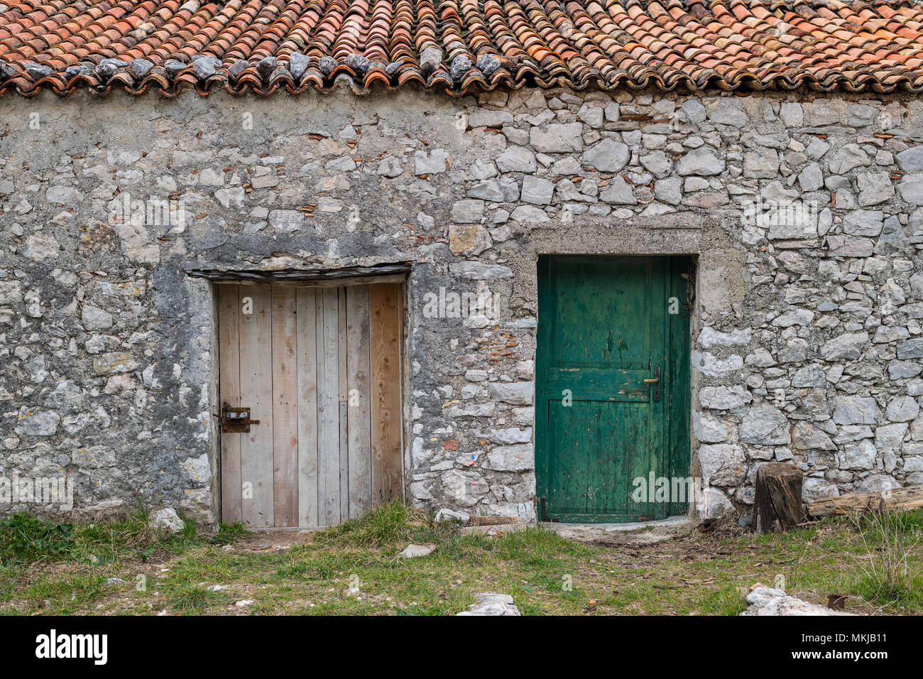 Stone house with two old wooden doors in Croatia Stock Photo - Alamy