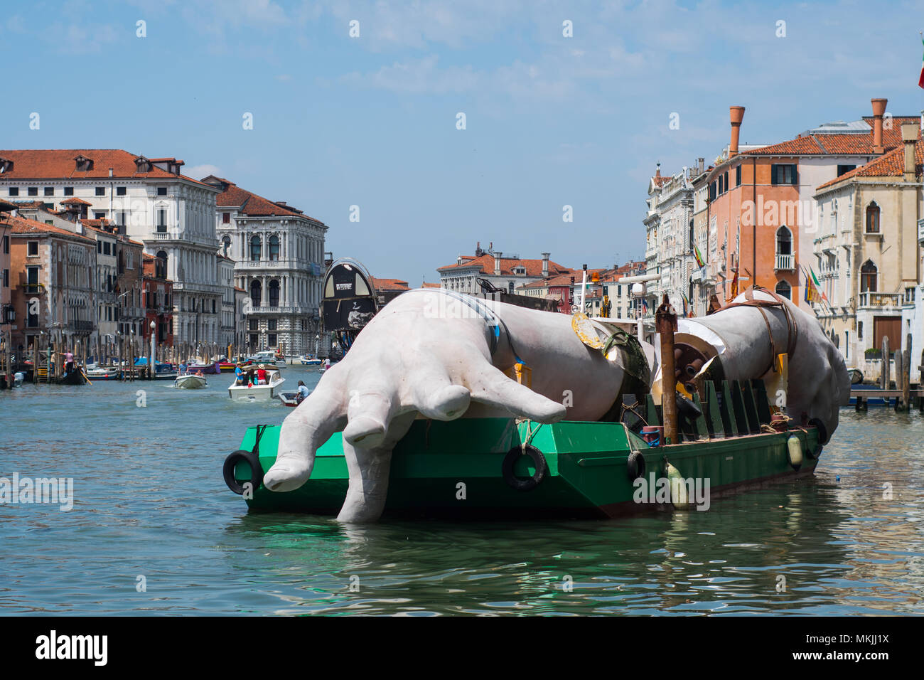 VENICE, ITALY. 08 MAY, 2018. One hand of the work of Lorenzo Quinn is disassembled and placed on a large barge for transport in Venice, Italy on 5 May 2018. The work of the artist Lorenzo Quinn 'Support', known as the 'big hands that support Venice', leave the Grand Canal to return to the artist's studio in Spain. © Simone Padovani / Awakening Stock Photo