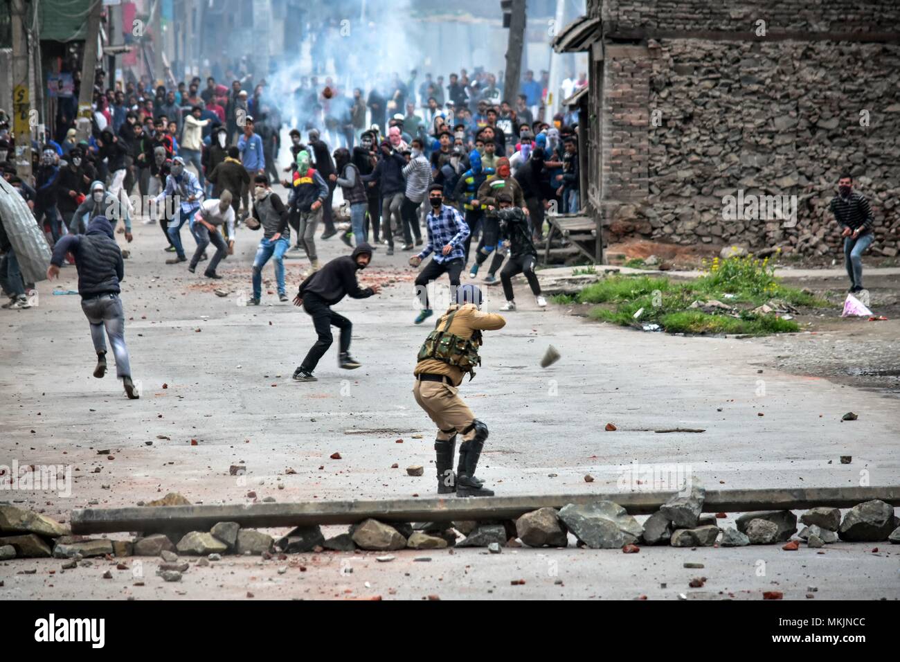 May 8, 2018 - Srinagar, J&K, India - Kashmiri protesters clash with government forces in Srinagar, Indian administered Kashmir. Fierce clashes broke out between government forces and Kashmiri protesters in Srinagar on Tuesday as the valley continued to remain tense over the killing of 11 people including 5 militants and 6 civilians in Indian administered Kashmir. Police used tear smoke shells and shot gun pellets to disperse hundreds of demonstrators who hurled rocks and chanted anti-Indian and pro-freedom slogans. Credit: Saqib Majeed/SOPA Images/ZUMA Wire/Alamy Live News Stock Photo