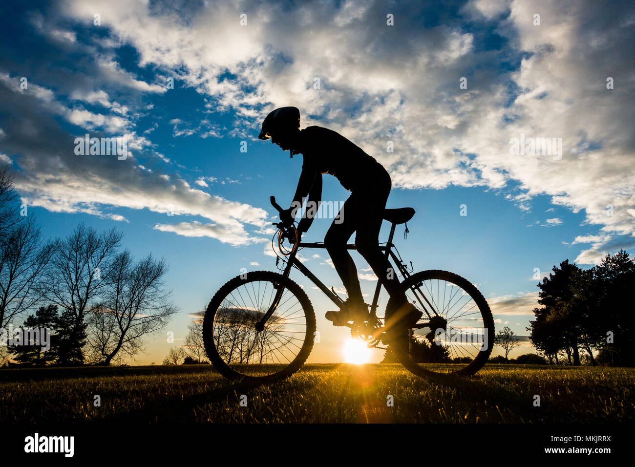 Mountain biker at sunset. UK Stock Photo