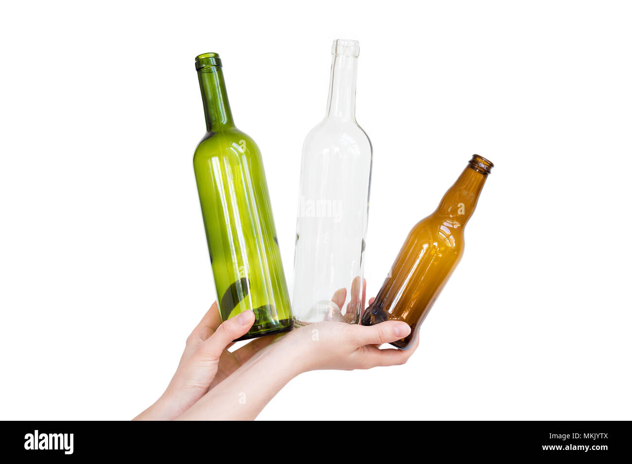 Female hand holding different types of glass bottles isolated on white