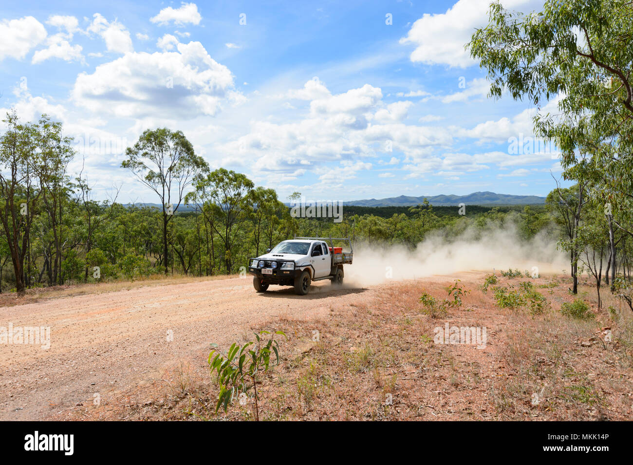 4x4 Car driving off-road on a dirt track with dust flying, going towards Maytown, Far North Queensland, FNQ, QLD, Australia Stock Photo
