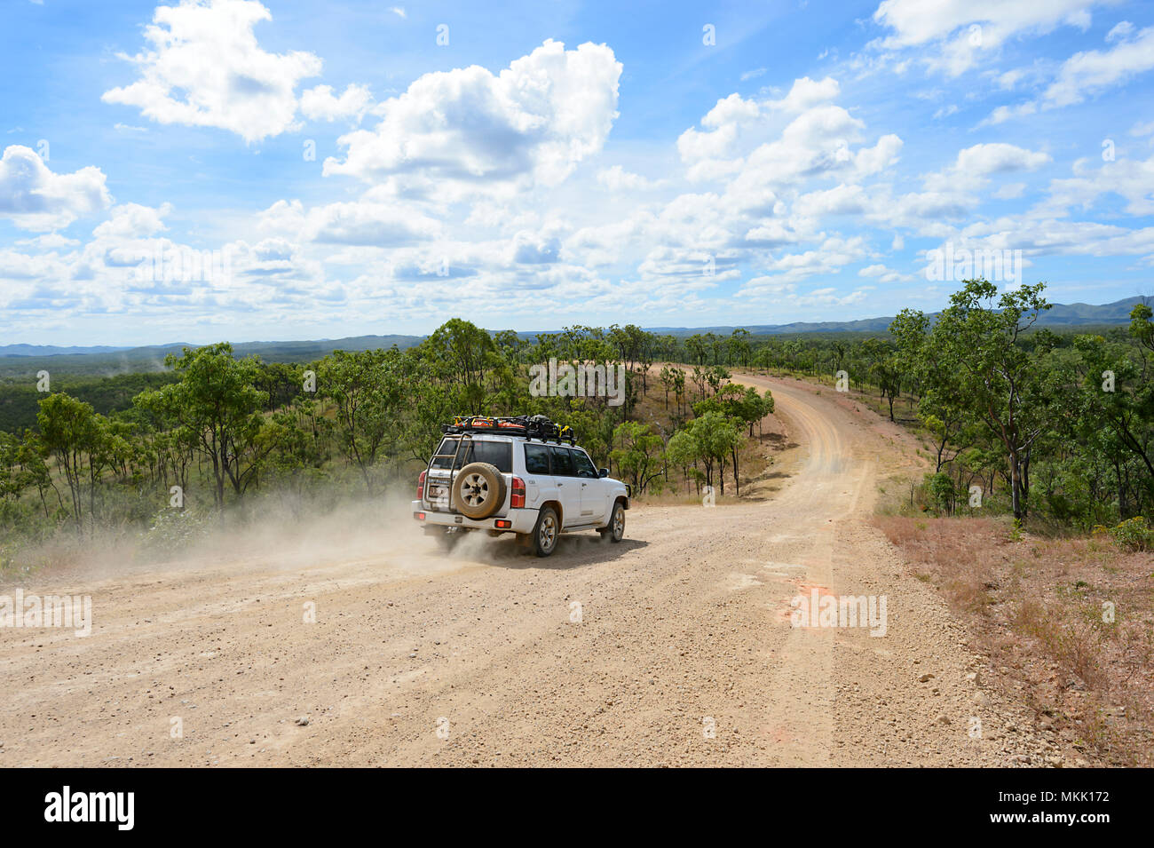 4x4 Nissan Patrol car driving off-road on a dirt track with dust flying, going towards Maytown, Far North Queensland, FNQ, QLD, Australia Stock Photo