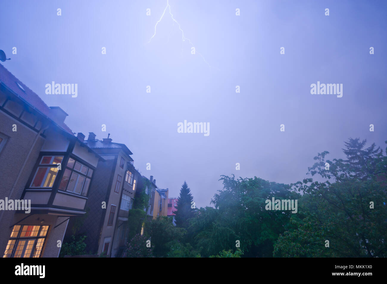 Thunderstorm over the outskirts of Vienna. Lightning strikes enlighten the night sky. Stock Photo