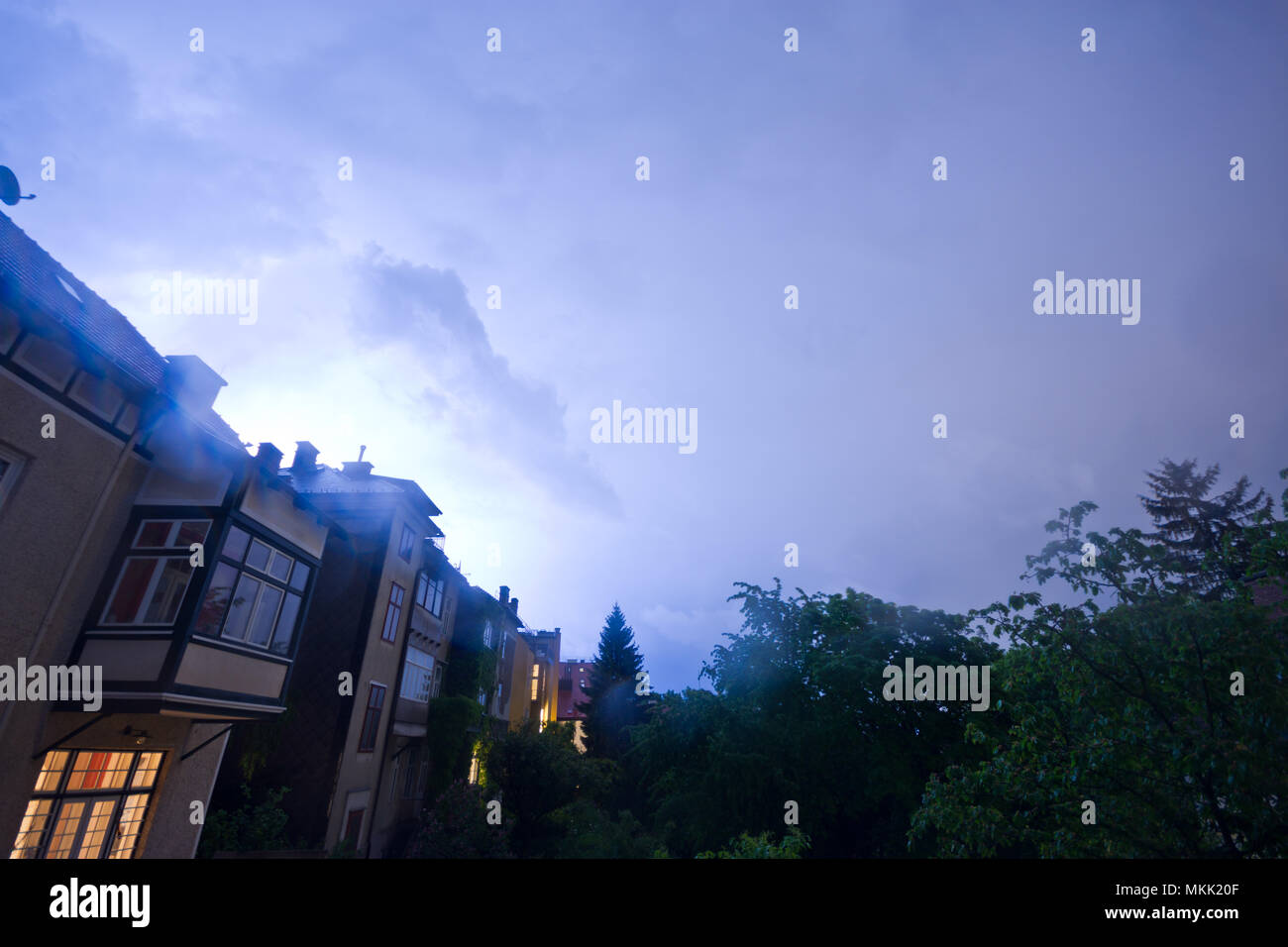 Thunderstorm over the outskirts of Vienna. Lightning strikes enlighten the night sky. Stock Photo