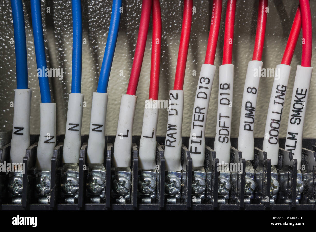 Close up of a water control system with electrical wiring and terminals