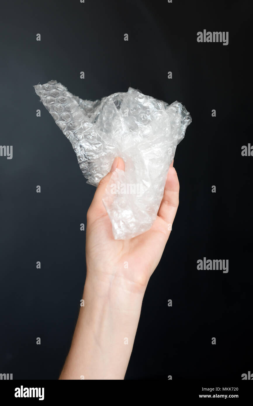 Plastic bubble wrap polyethylene package material in hand. Recycling