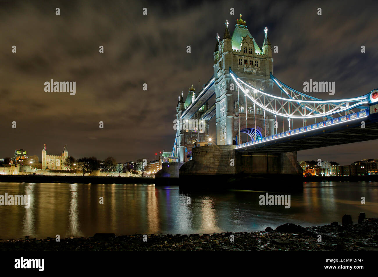 Tower Bridge in London, at night, low POV from the foreshore, one of the most iconic man made structures in the world. Stock Photo