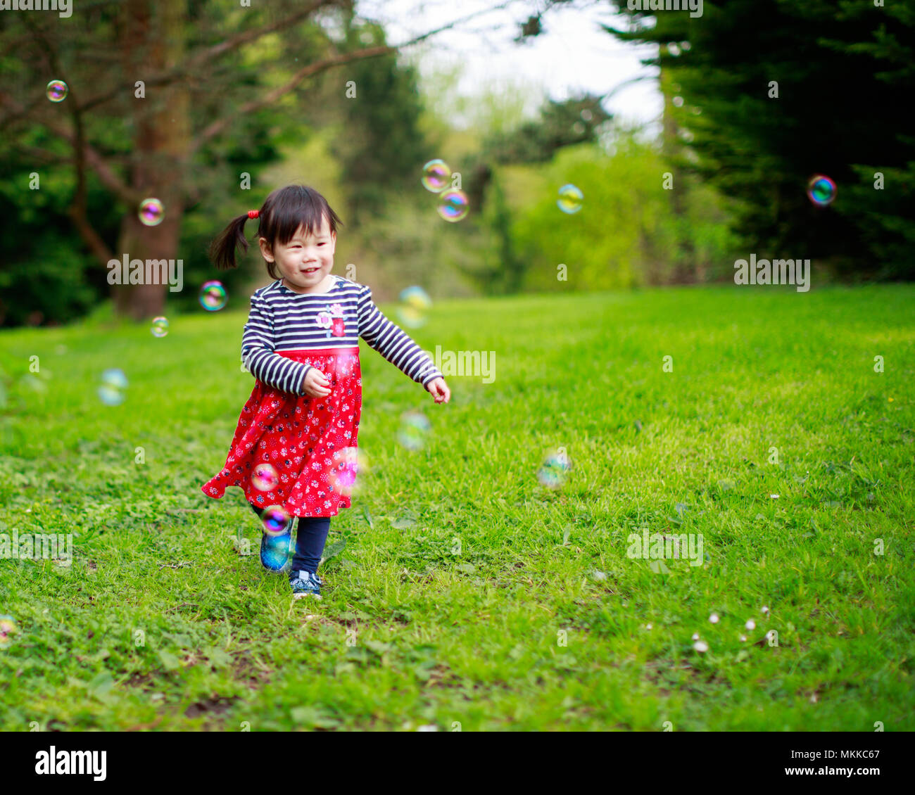 baby girl play bubble at spring garden Stock Photo - Alamy