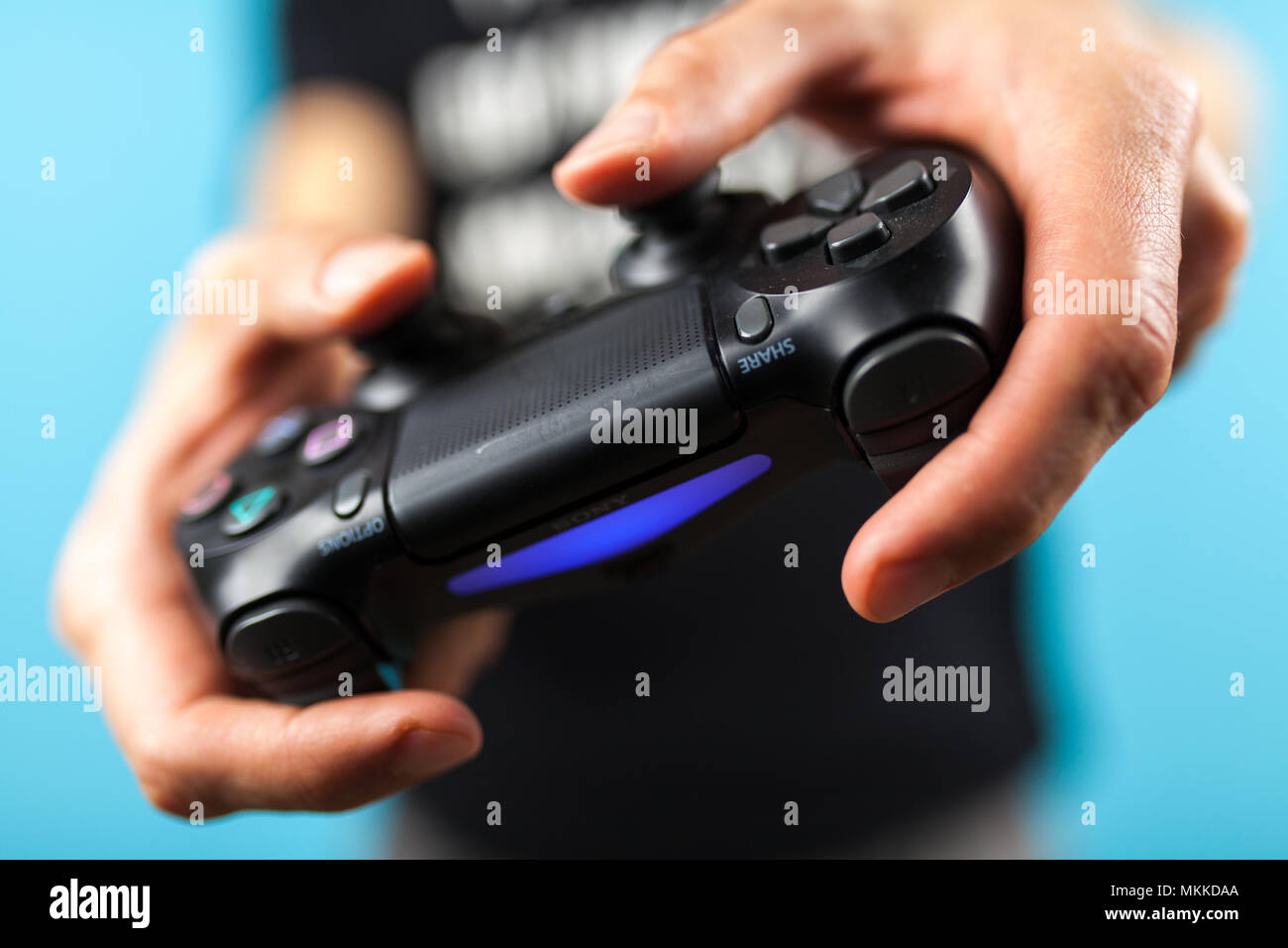 Male hands holding a PS4 controller Stock Photo - Alamy