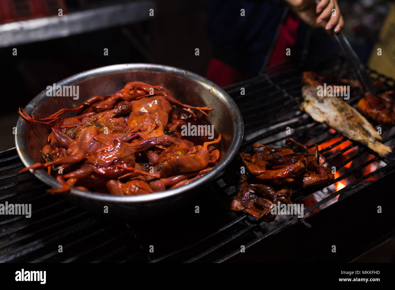 Chicken prepared for grill in cambodian night street food market hires