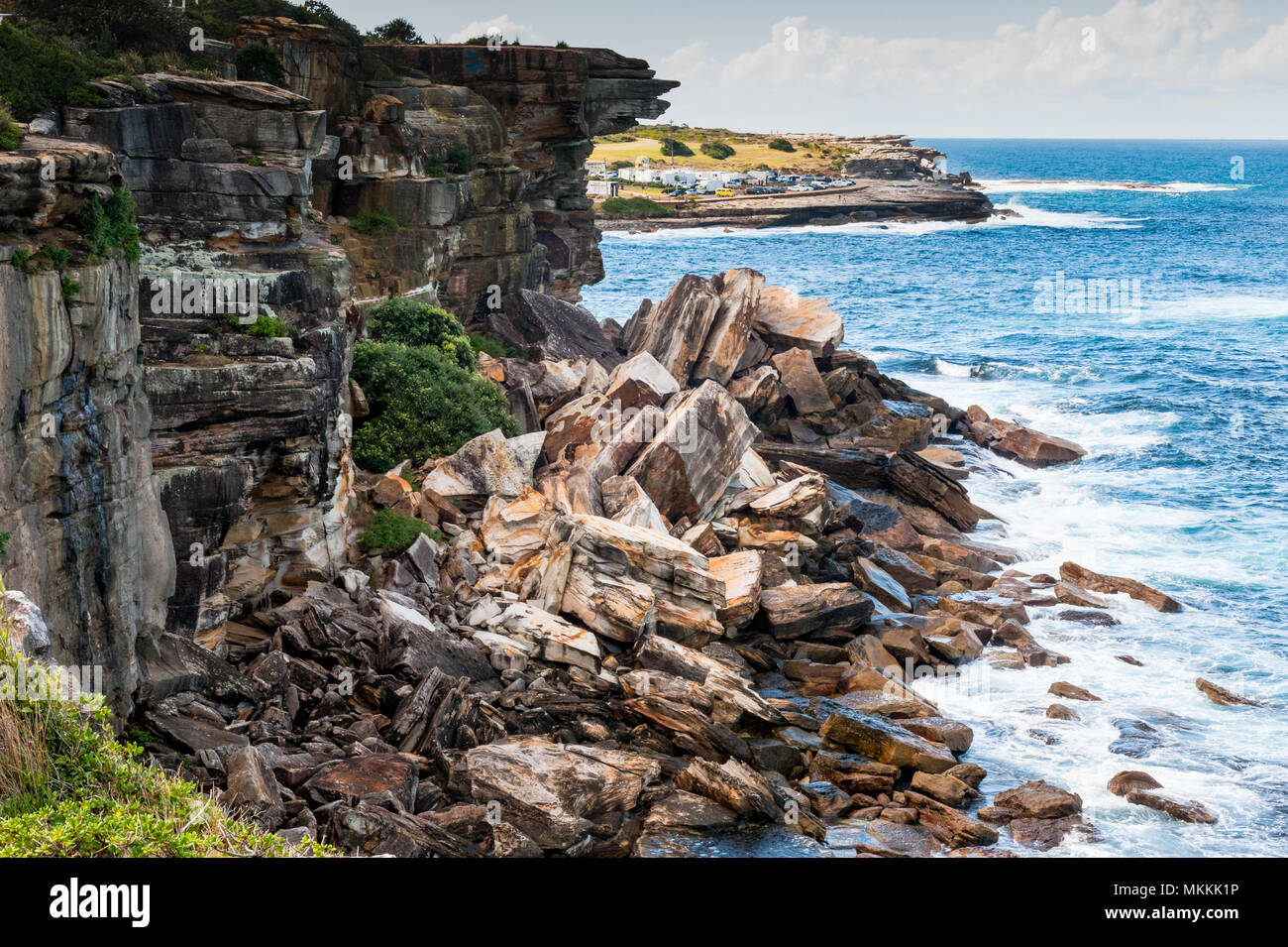 The stunning scenery along the famous Coogee beach walk to Bondi Beach, Sydney Australia. In this shot massive rocks and boulders have fallen. Stock Photo