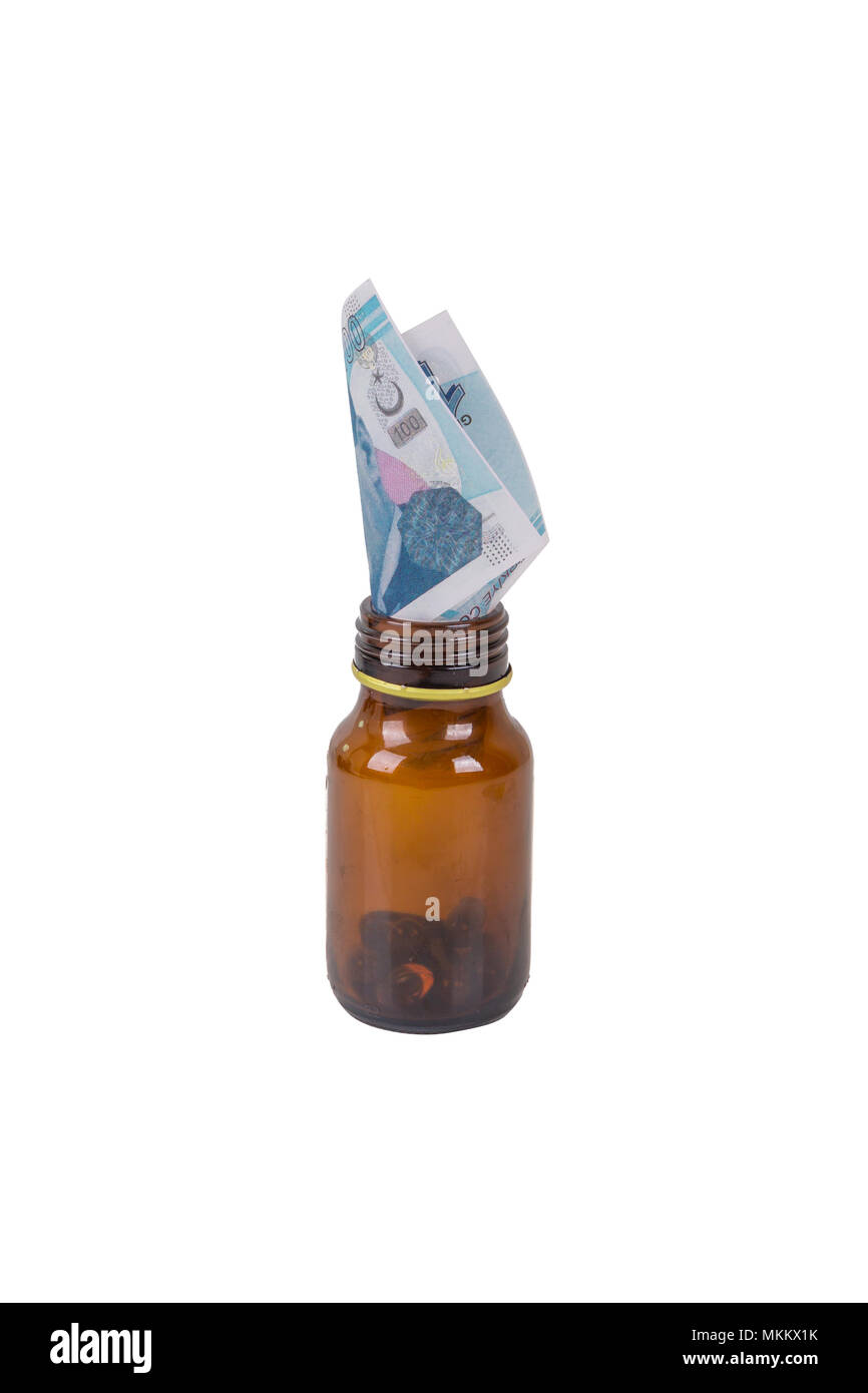 Stack of Turkish liras banknotes inside and medicine pills bottle with