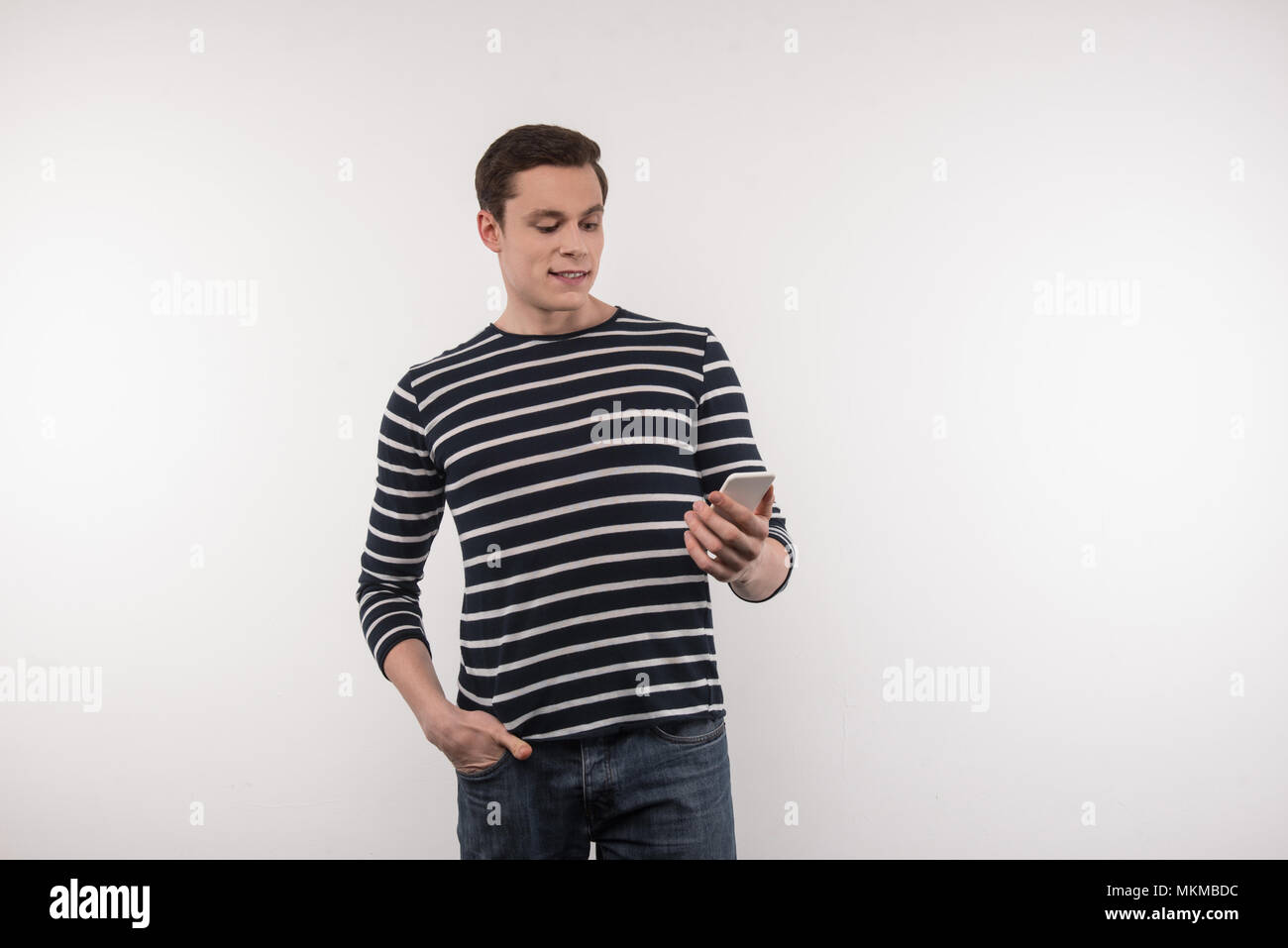 Happy nice man looking at the smartphone screen Stock Photo