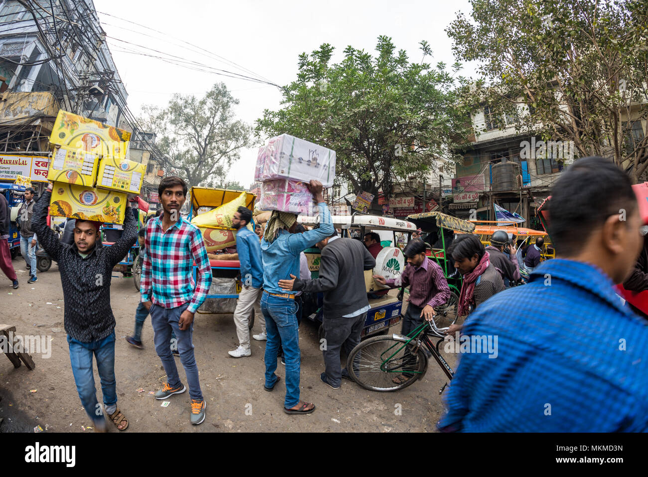 Delhi, India - December 11, 2017: crowd and traffic on street at Chandni Chowk, Old Delhi, famous travel destination in India. Chaotic city life, work Stock Photo