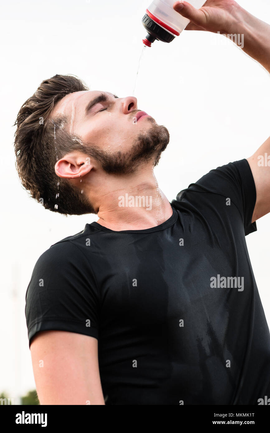 Man drinking from water bottle during sports Stock Photo